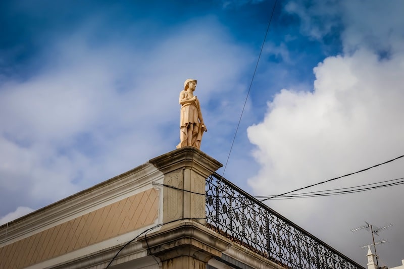 Statue of a boy atop a roof portugal