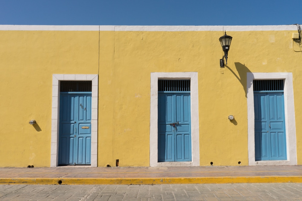 yellow building with blue doors campeche mexico