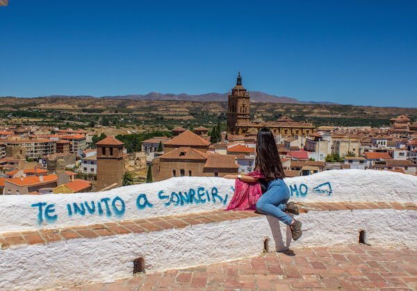 The back of a sitting woman overlooking Guadix Spain