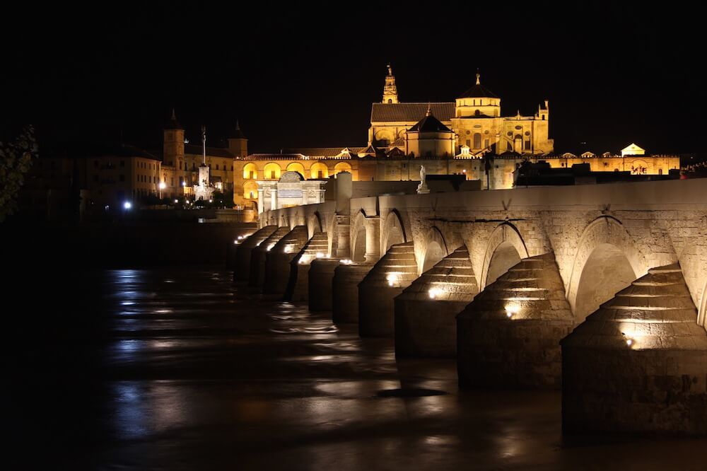 mezquita cordoba spain at night with bridge