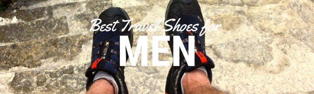 Header image for a blog about best travel shoes for men. Image shows a close up of men's feet wearing hiking shoes. The words "best travel shoes for men" are laid over top the image