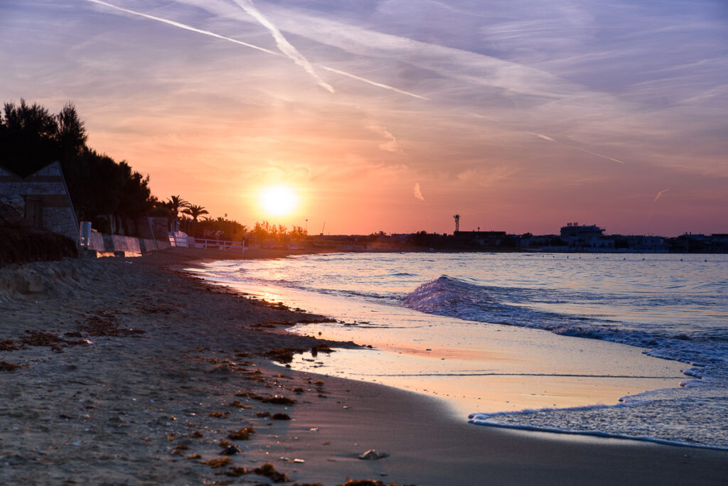 sunset over the beach in torre canne, puglia, italy