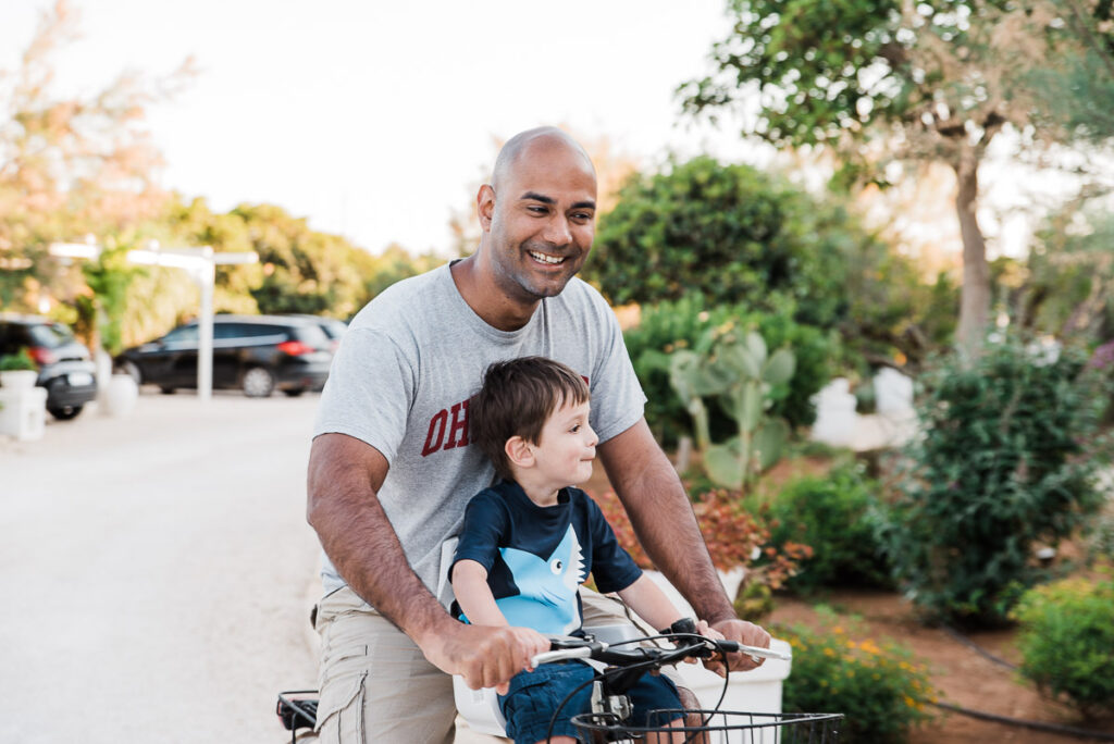 dad and son riding a bike