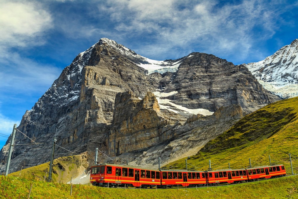 Famous electric red tourist train coming down from the Jungfraujoch station(top of Europe) in Kleine Scheidegg,Bernese Oberland,Switzerland,Europe