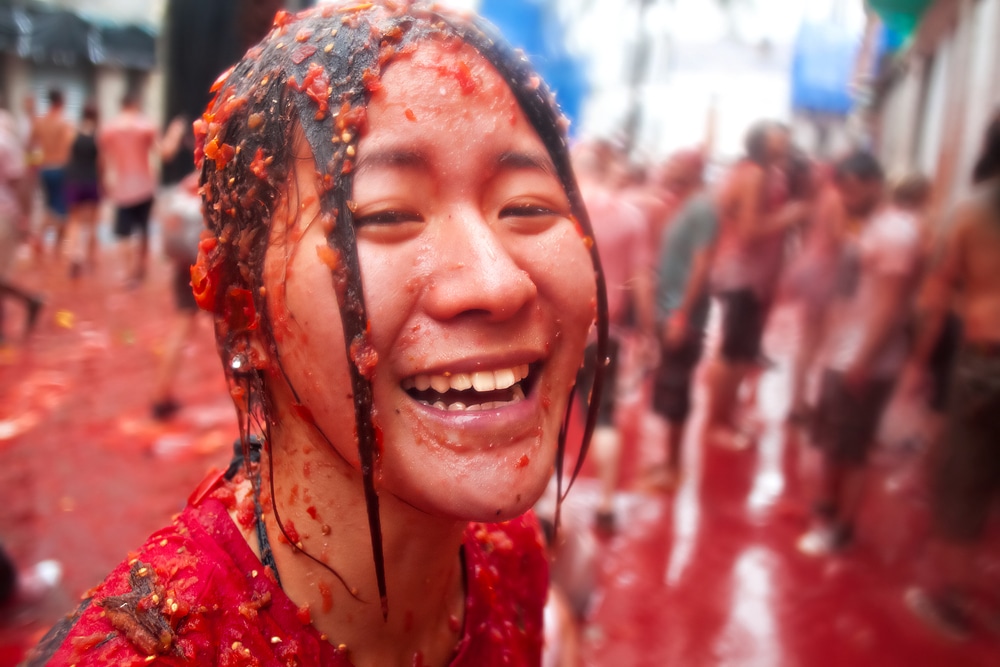 Bunol, Spain - August 28: The girl in crushed tomatoes laughs on Tomatina festival in Bunol, August 28, 2013 in Spain