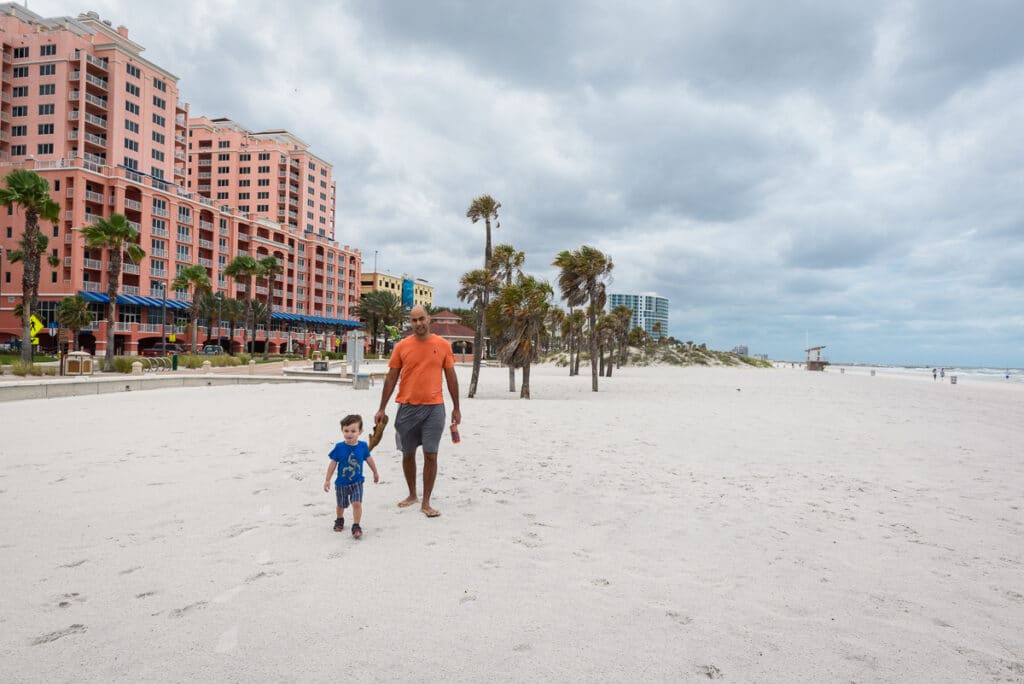 dad and son walking on clearwater beach