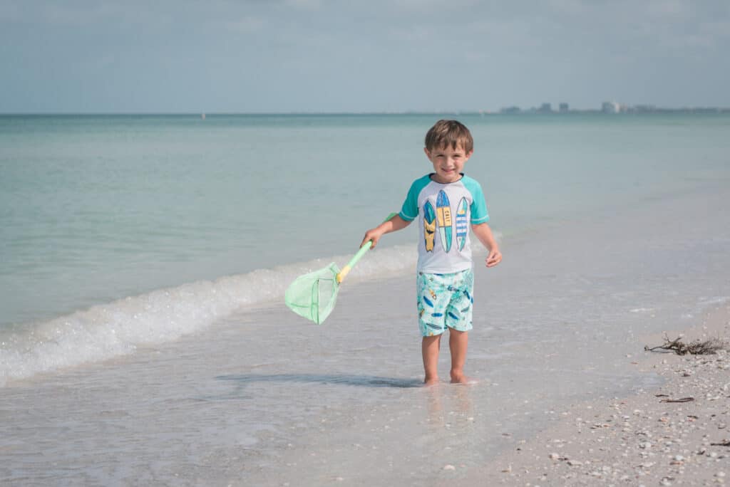 kid on beach in pass-a-grille, st pete beach, florida