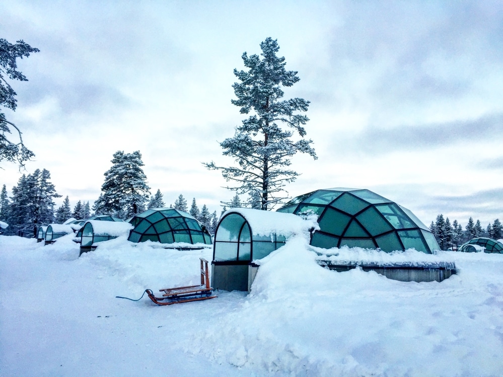 glass igloos covered in snow in Kakslauttanen resort