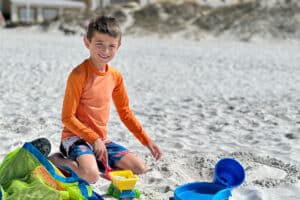 my son playing on the beach
