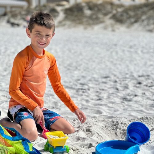 my son playing on the beach