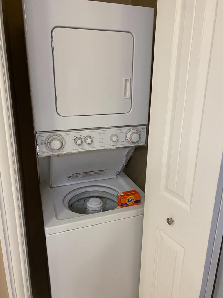 stacked washer and dryer in bathroom of suite