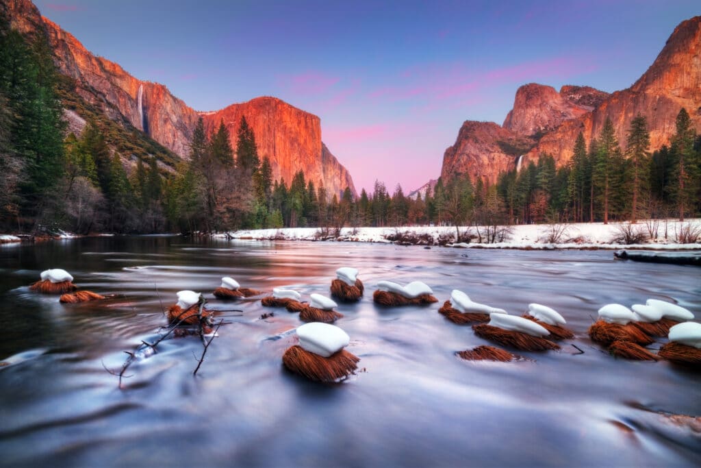 view of lake with mountains in background in Yosemite national park during winter