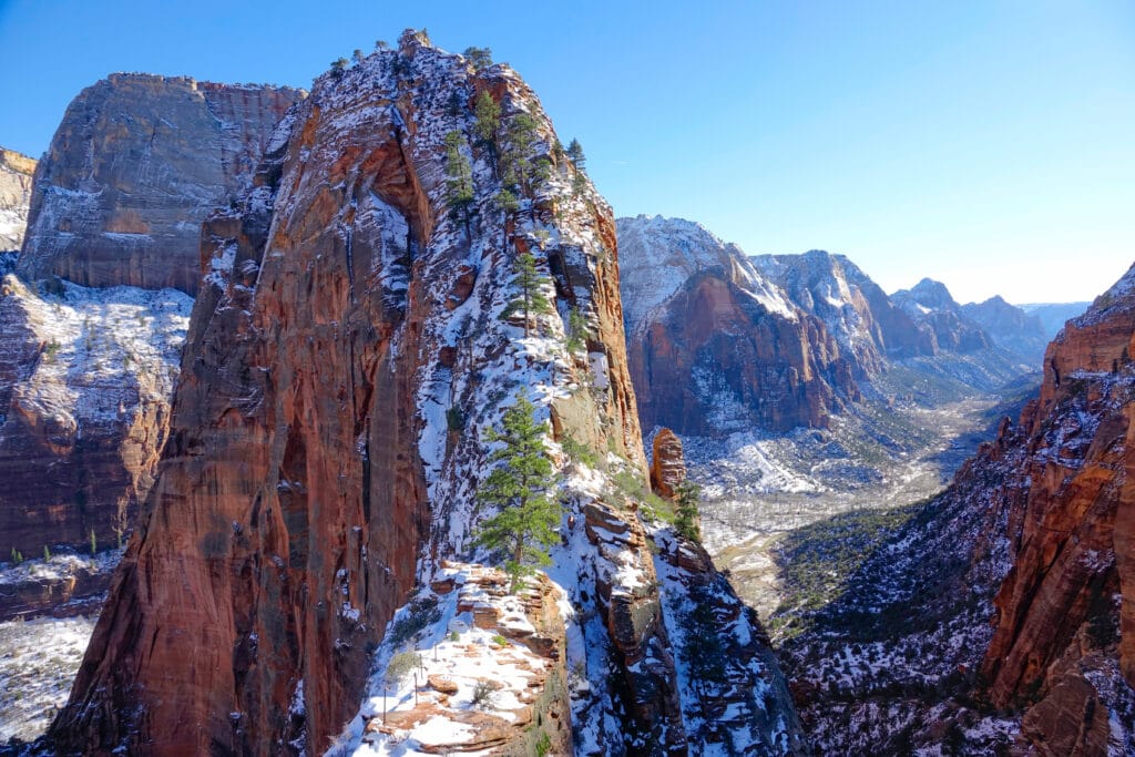 view of tip of angels landing and surrounding crags dusted with snow in Zion national park in winter