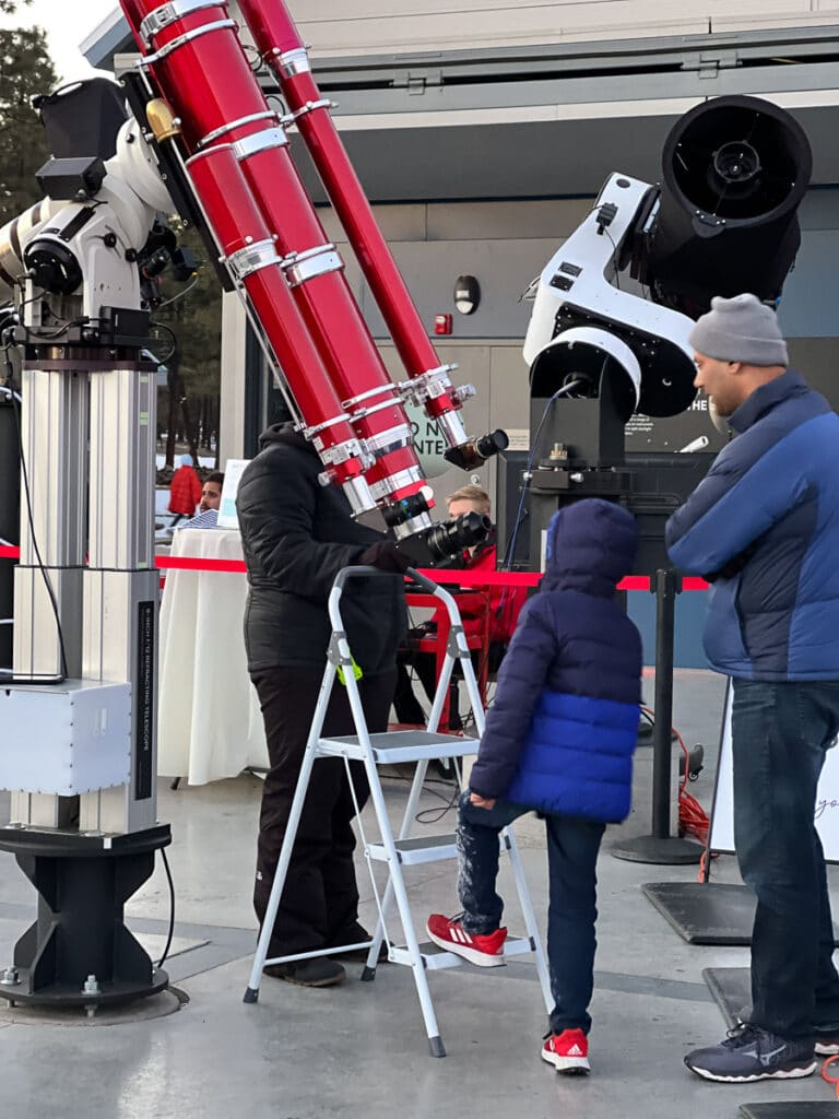 Kid looking through a telescope at Lowell Observatory.