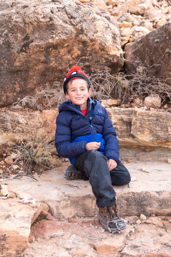 child on a Grand Canyon hike with crampons on his hiking boots