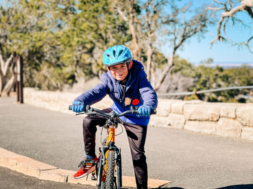 son biking on Hermit Road in Grand Canyon