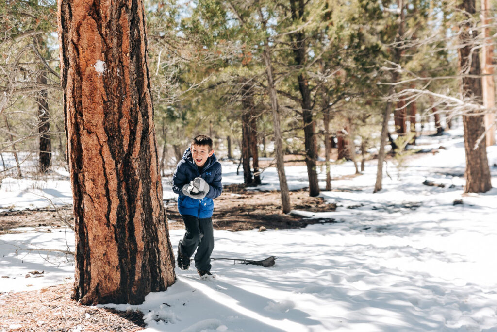 my son throwing snowballs on Shoshone Point Trail