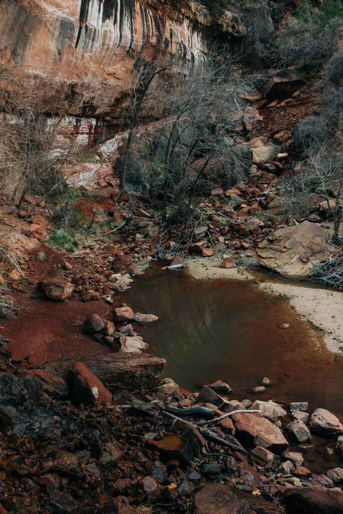 walking behind waterfall at emerald pools trail