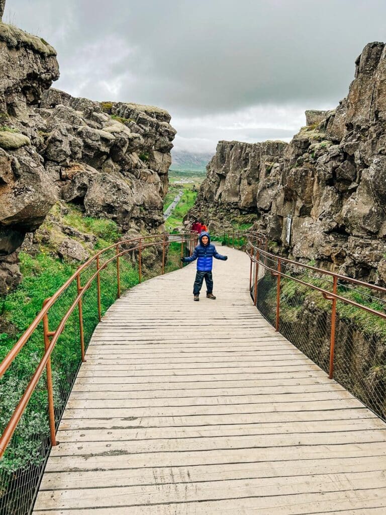 Standing in the continental rift at Thingvellir National Park