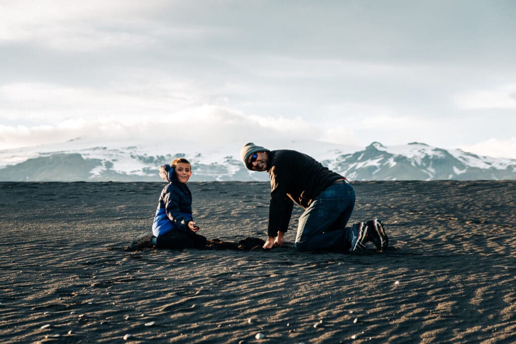 My son and husband playing on the black sand beach in Iceland.