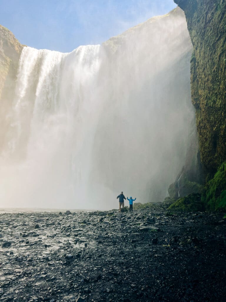 my son and husband getting up close to Skogafoss Waterfall