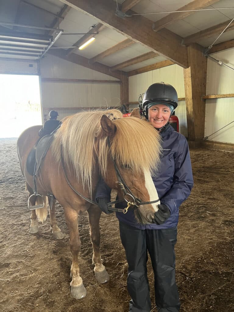 me and a horse in the barn before our ride