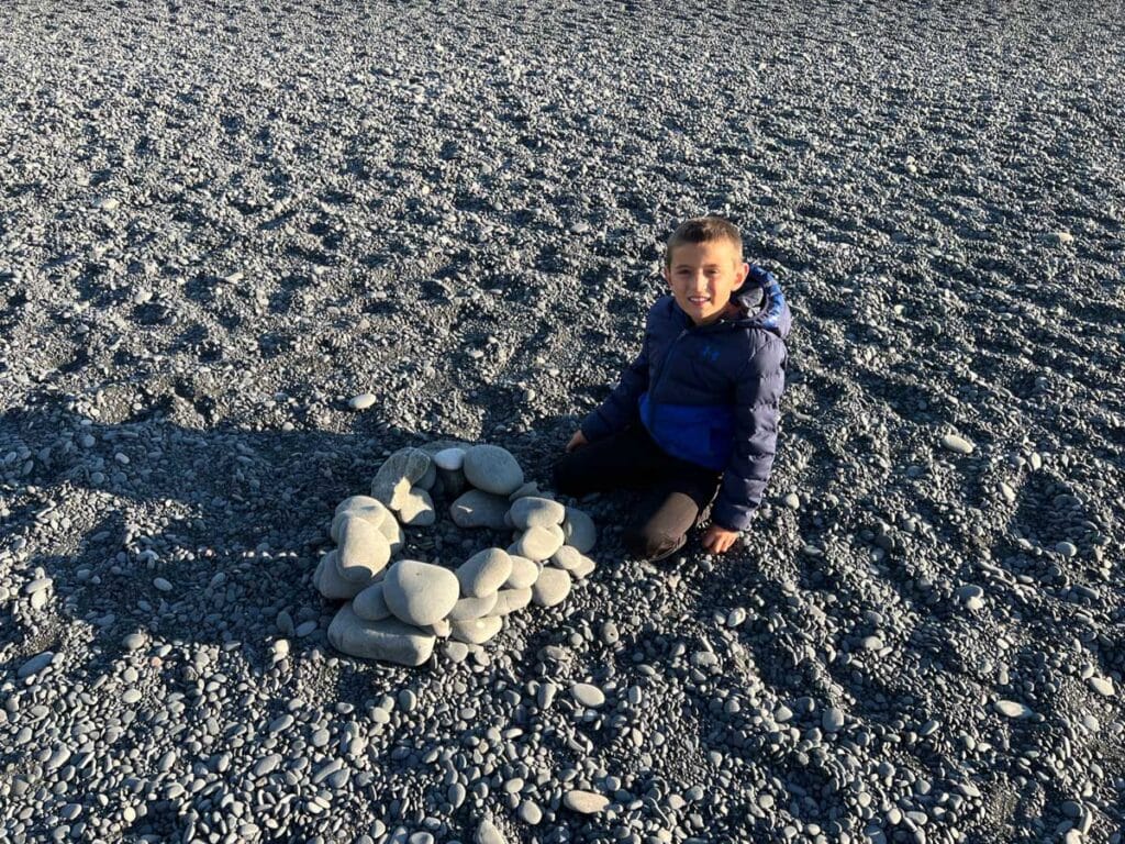 building castles on Reynisfjara Black Sand Beach in Iceland