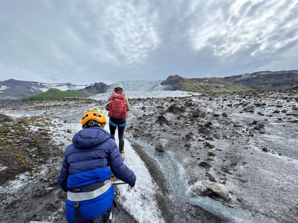 my son hiking behind the tour guide on the glacier
