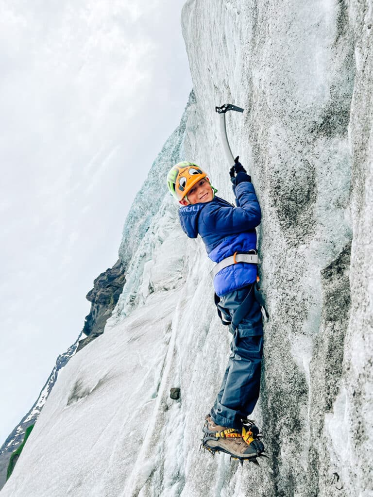 my son ice climbing on a glacier hike