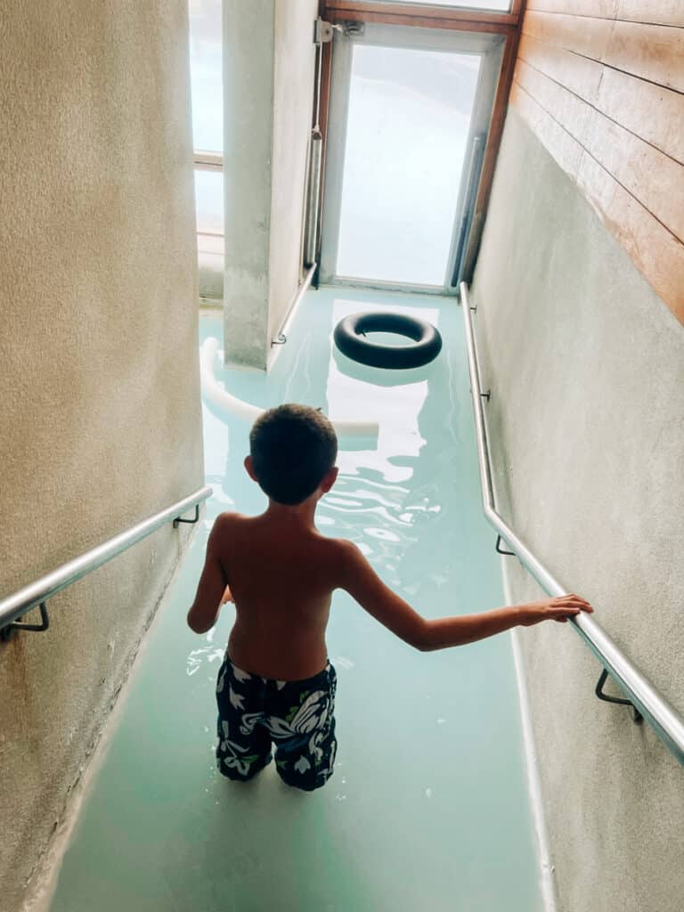 m son entering the Lagoon at Silica Hotel in Iceland