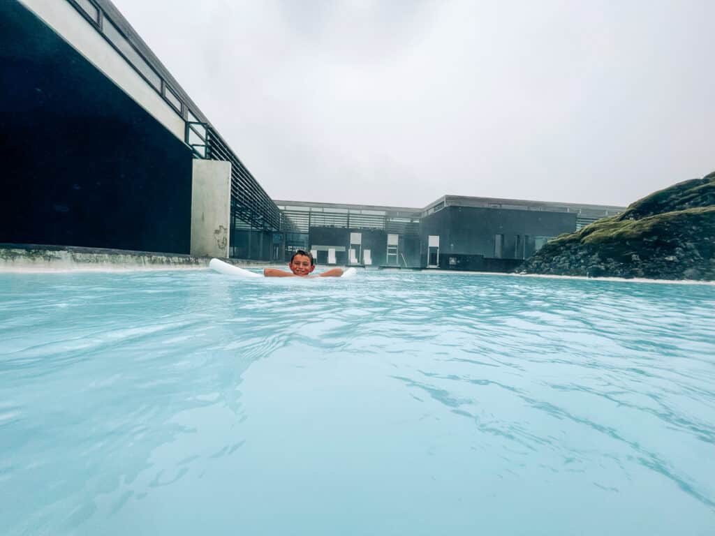 my son floating at the Lagoon at Silica Hotel in Iceland