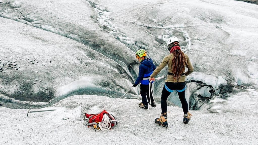 My son using a safety line to peer inside the crevices on a Skaftafell Glacier Hike in Iceland