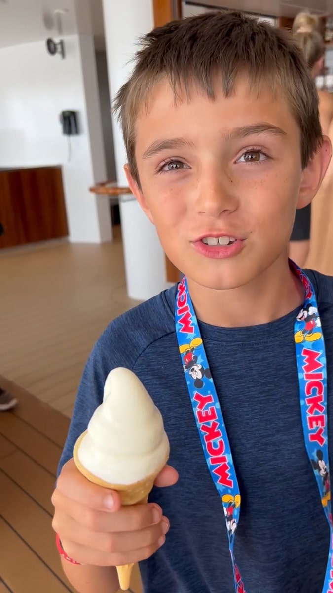 my son eating an ice cream cone on the Disney Wish cruise ship