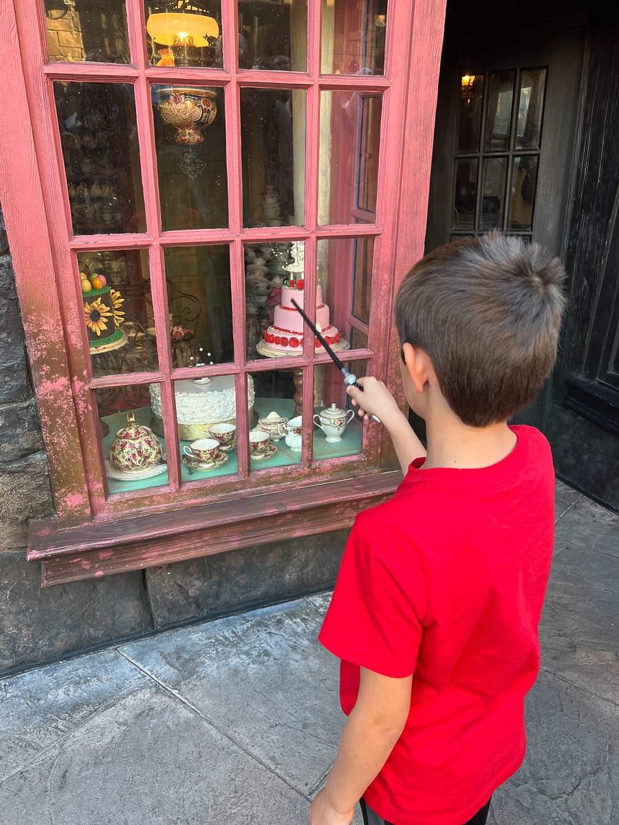 my son using his wand to cast spells as Universal Studios