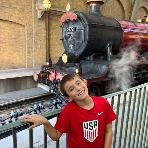 my son in front of the Hogwart's Express train at Universal Studios