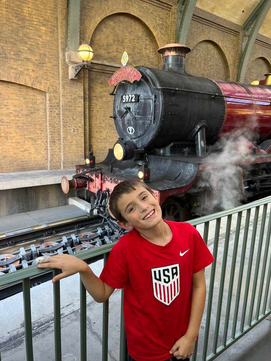 my son in front of the Hogwart's Express train at Universal Studios
