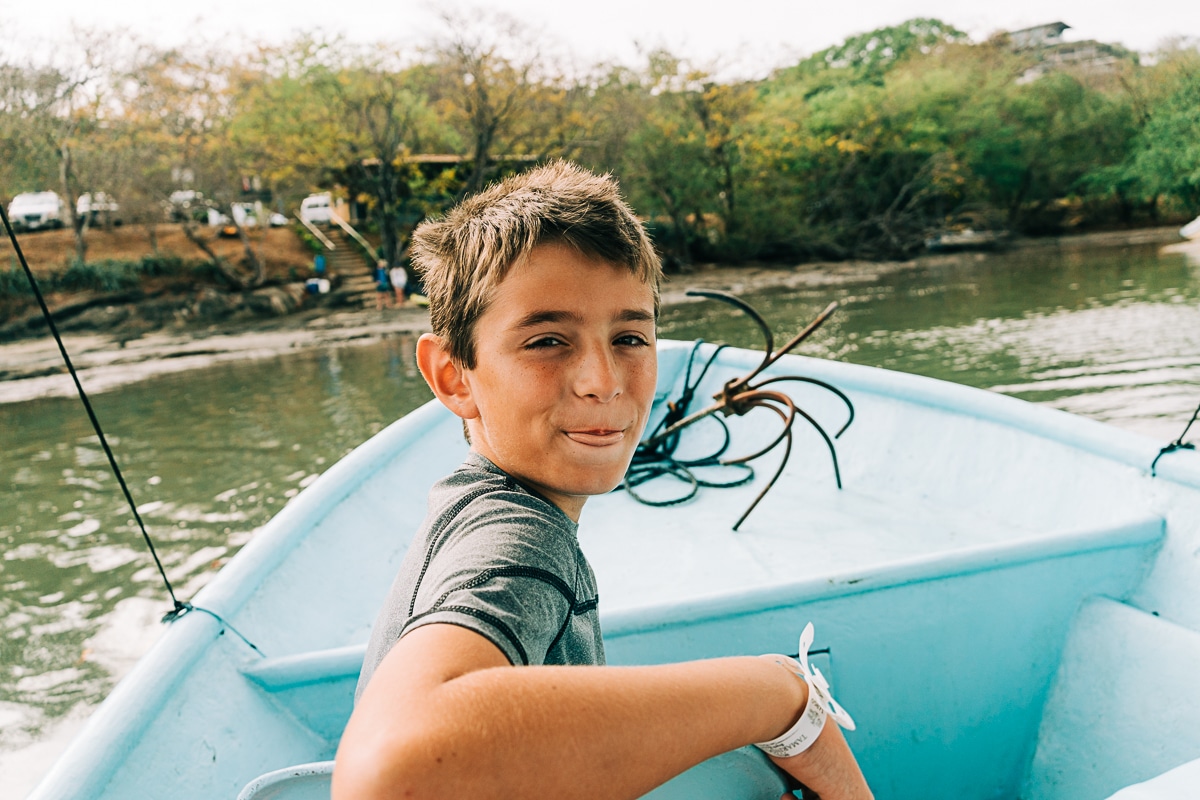 my son at the front of the boat on our Tamarindo estuary tour