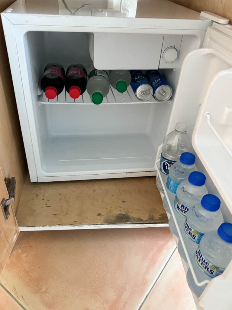 mini fridge was stocked with water, soft drinks, and beer