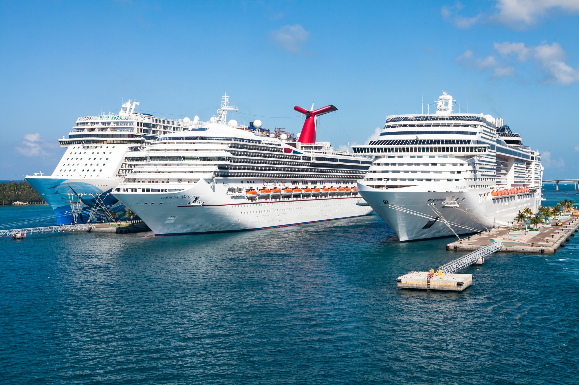 three cruise ships side-by-side in port