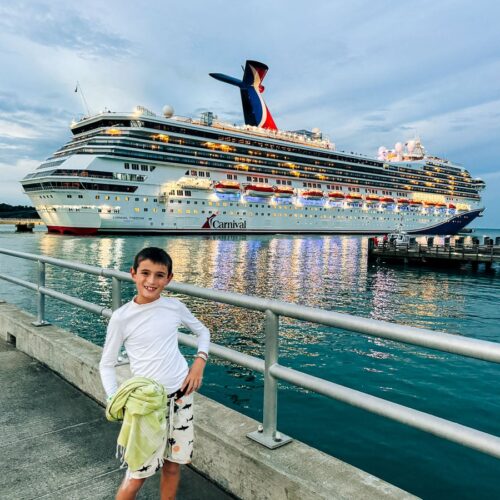my son standing in front of the Carnival Freedom