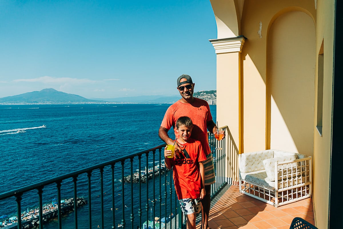 my husband and son on the balcony of our room at Imperial Hotel Tramontano in Sorrento