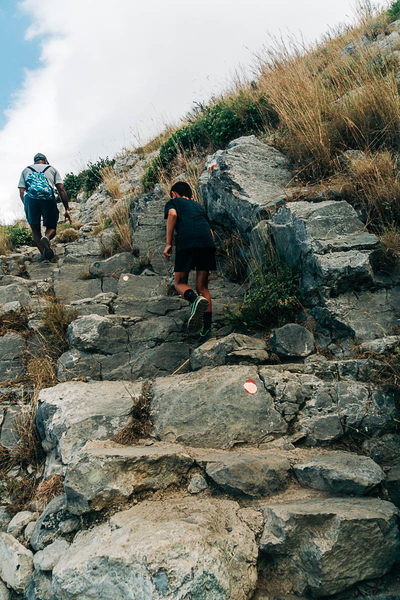 scrambling over rocks on the path of the gods