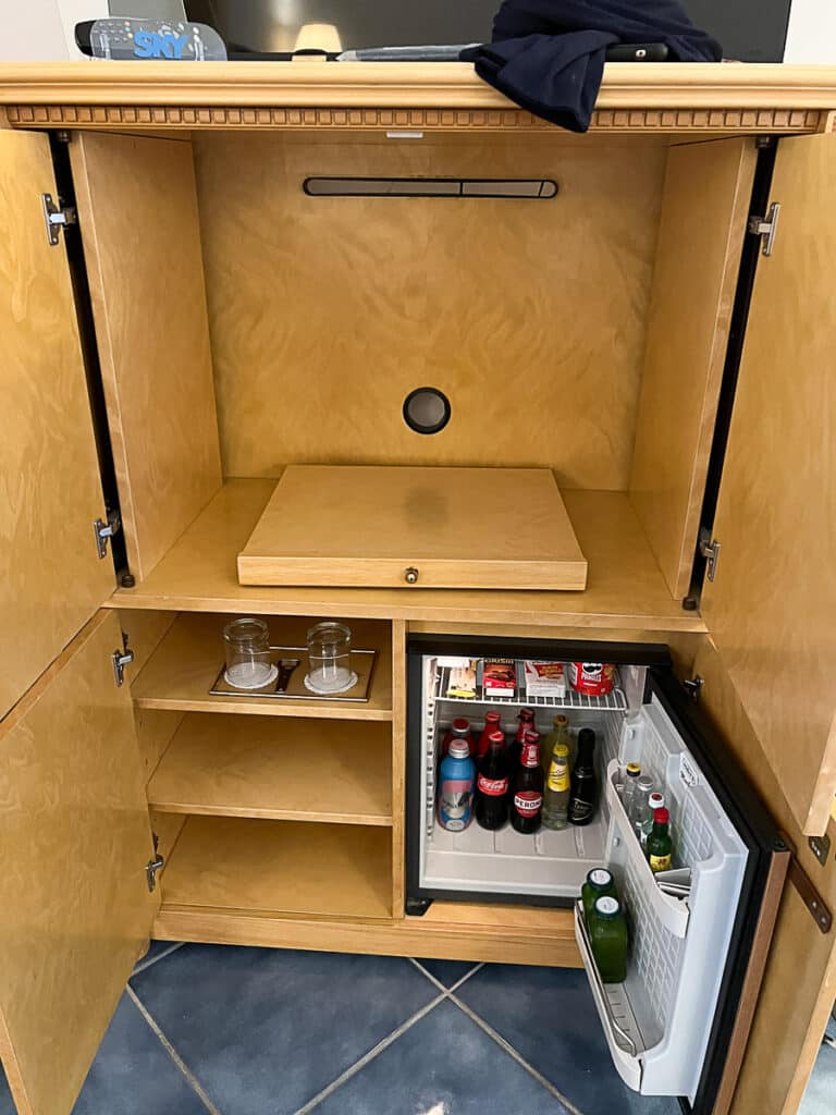 stocked mini fridge inside the cabinet