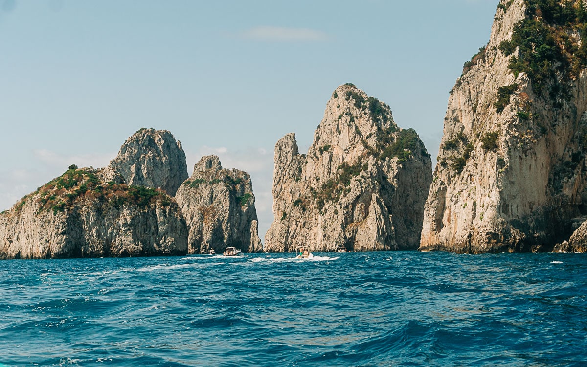 view of the faraglioni rocks from our boat