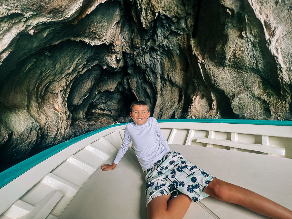 my son on the boat inside a cave