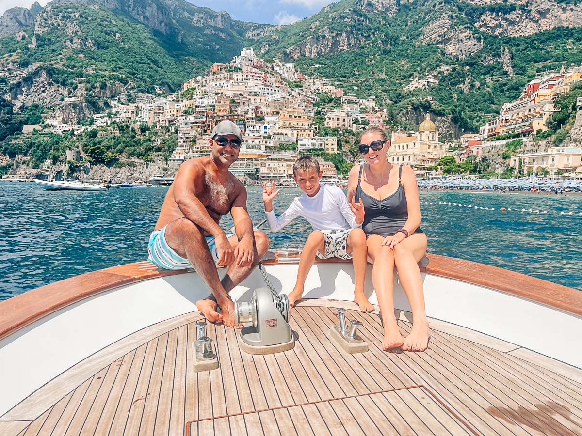 my family on a boat with positano in the background