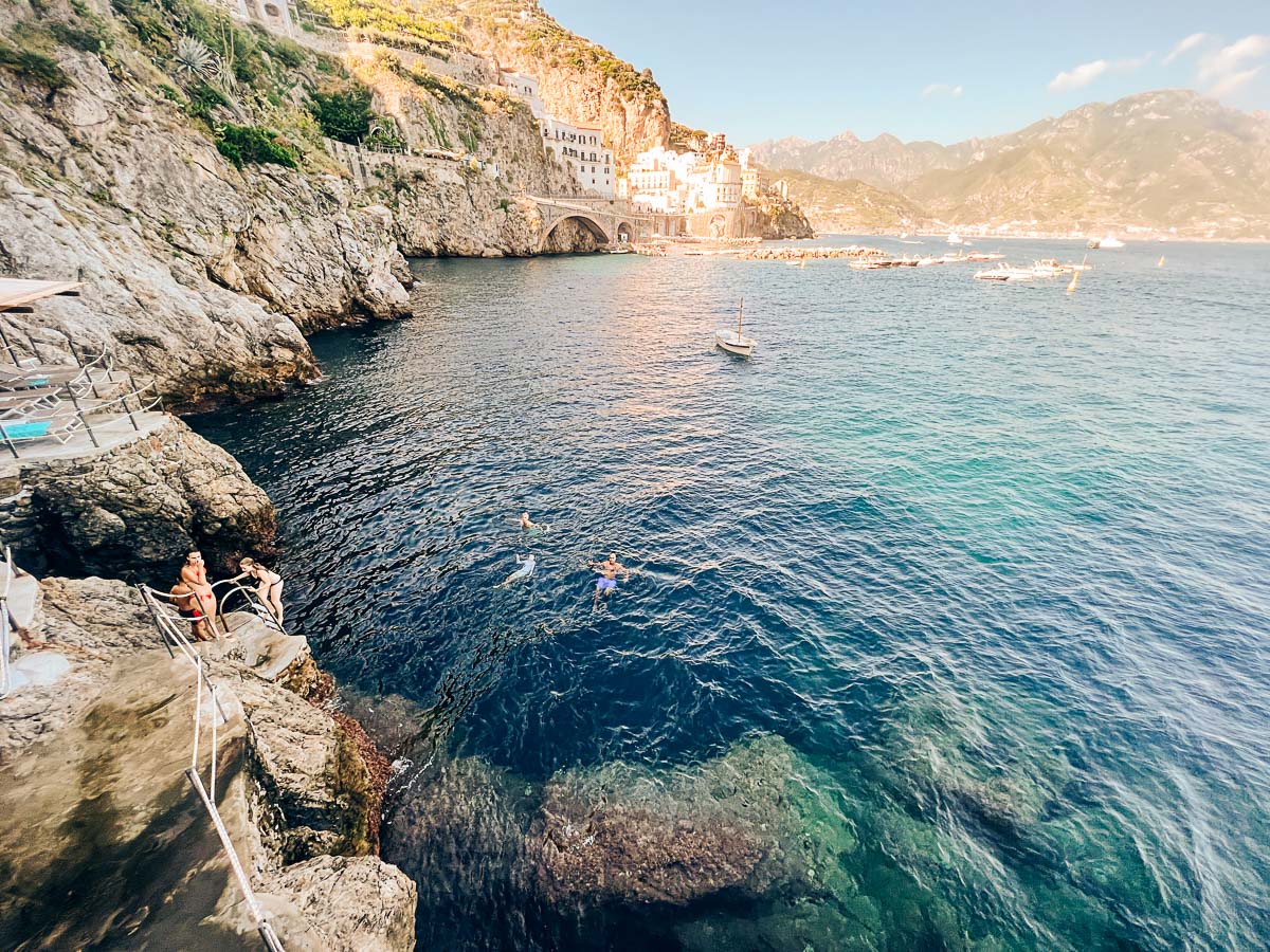 jumping in the water from the pool at Hotel Luna Convento in Amalfi