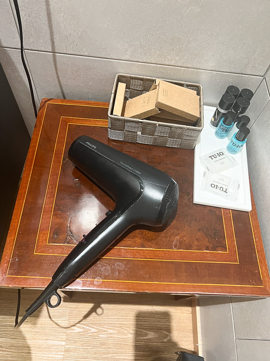 a hair dryer on the bathroom table in the hotel
