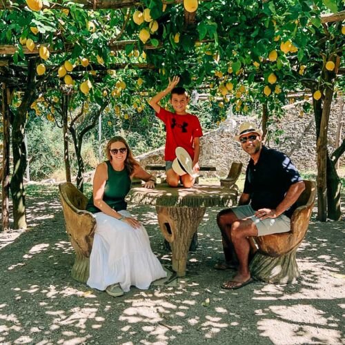 me and my family sitting under the lemon trees