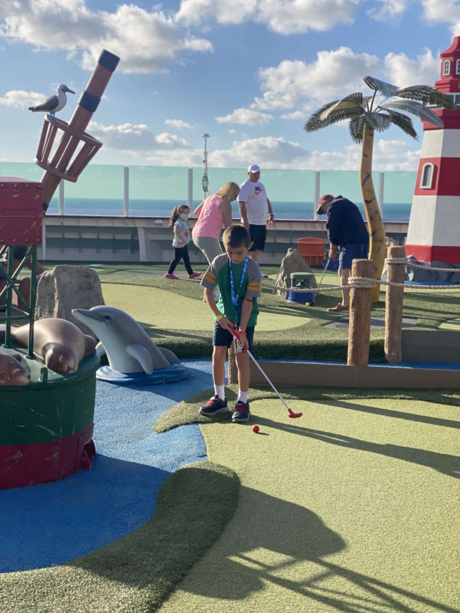 my son playing mini golf on Independence of the Seas